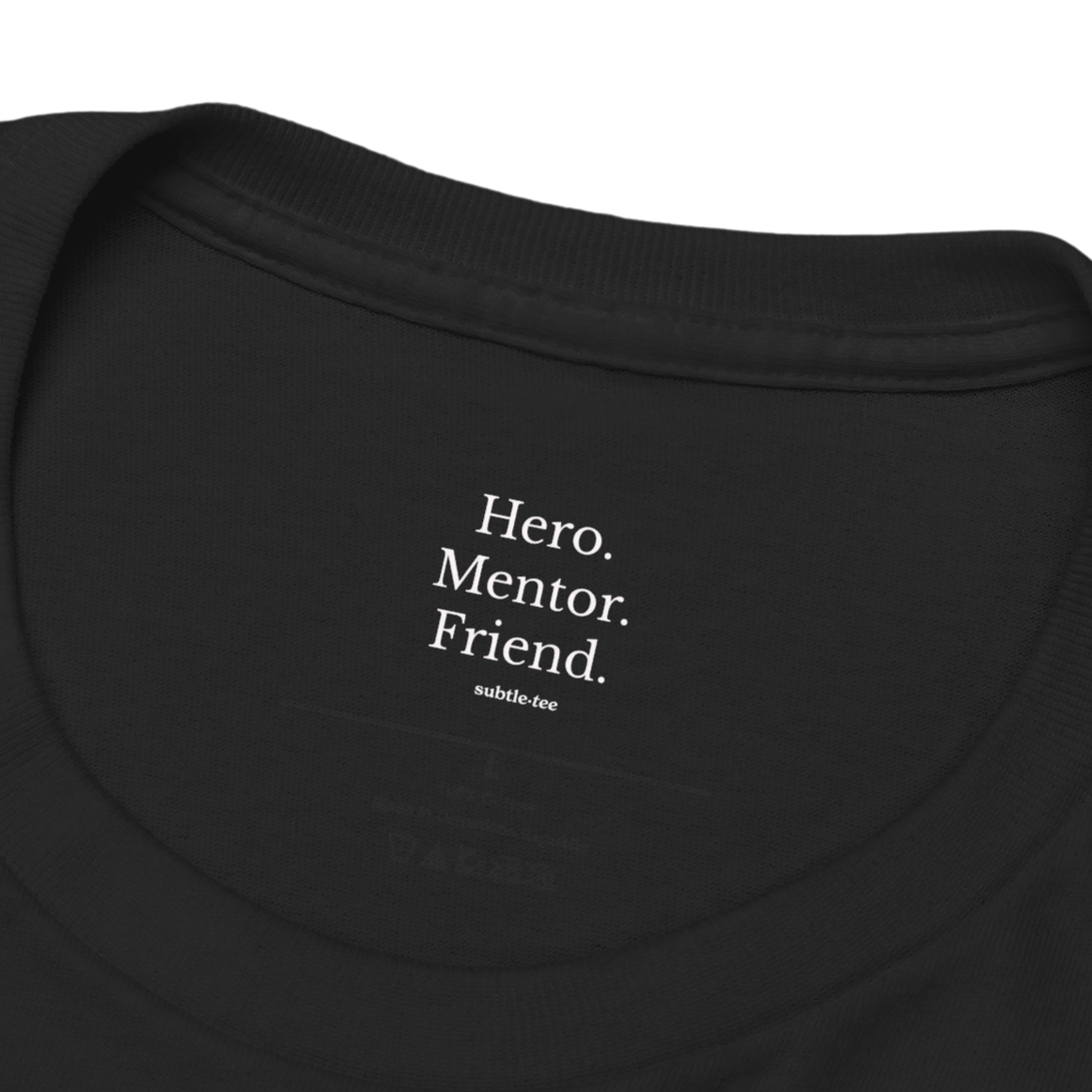 Hidden collar message inside black T-shirt reading “Hero. Mentor. Friend.” from Subtletee, a heartfelt token of gratitude and appreciation.