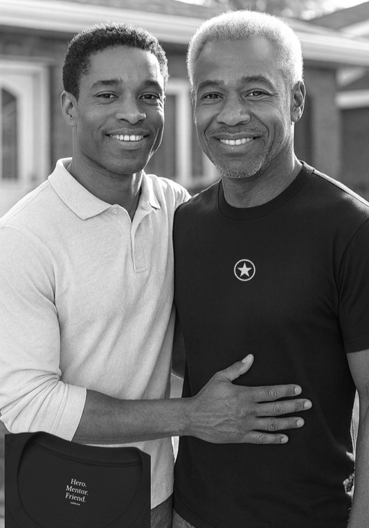 Father and son smiling warmly outside while wearing the Hero Mentor Friend T-shirt, a meaningful gift that honours quiet strength and guidance.